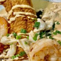 Seafood Catfish · Fried catfish topped with sauteed shrimp, buttered crab and lobster claw meat over spinach a...