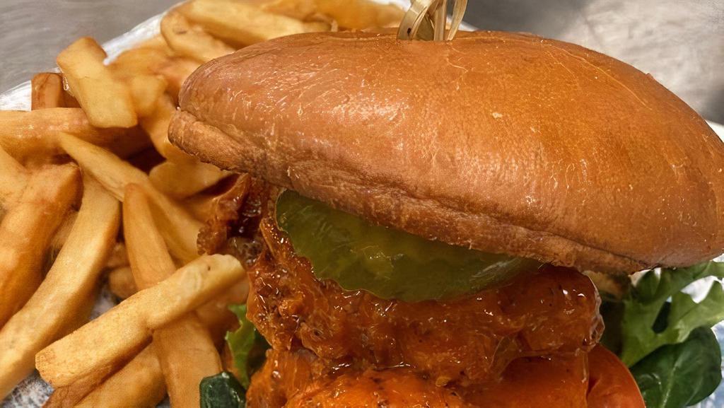 Fried Chicken Sandwich · Buttermilk fried chicken thighs tossed in your choice of Buffalo or Hot Honey sauce with lettuce, tomato, house made pickles on a brioche bun with cilantro aioli.
