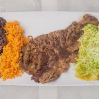Tampiquena · Dos bistek asados con arroz, frijoles, dos enchilada y aguacate/ two roasted steaks with ric...