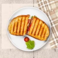 Monte Cristo Panini · Turkey, ham, Swiss cheese, cheddar cheese, lettuce, tomato, and honey mustard on toasted bre...