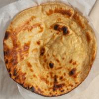 Paratha · Layered and rolled dough, cooked on griddle until golden brown.
