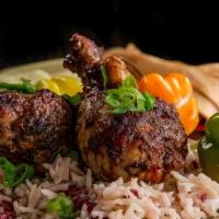 Jerk Chicken · Jerk Chicken is served over Rice and Peas or White Rice with Mixed Vegetables