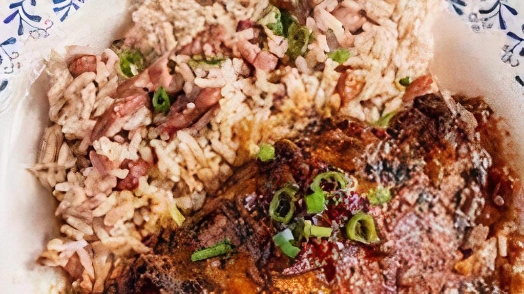 Brown Stew Chicken · Brown Stew Chicken is served over Rice and Peas or White Rice with Mixed Vegetables