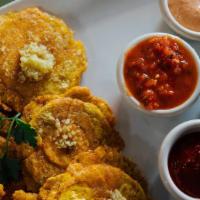 Tostones · Fried mashed green plantains with an assortment of homemade sauces included.