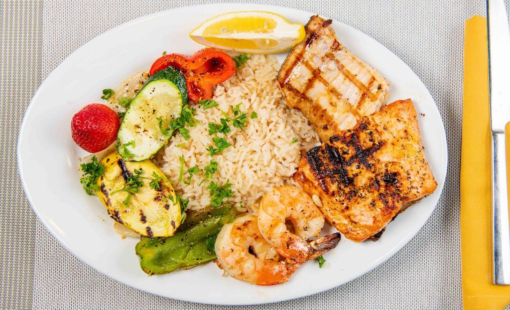 Seafood Mixed Grill · Swordfish, salmon, and shrimp in a lemon pepper sauce served with an assortment of grilled veggies and vermicelli rice.