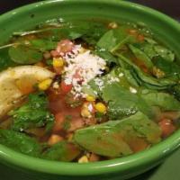 Spicy Chicken Veggie Soup · Grilled chicken, fire roasted corn salsa and baby spinach in a spicy broth topped with cotij...