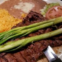 Carne Asada · Charbroiled skirt steak served with guacamole and green onions
