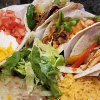 Cancun Tacos (Fajita Style) · Three soft flour tortillas with your choice of grilled chicken or grilled steak with sautéed...
