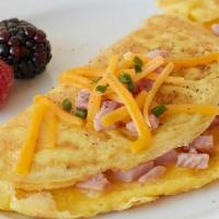Ham & Cheese Omelette · Three eggs with ham (black forest) and melted double American cheese, served with a choice o...