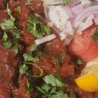 Goat Karahi · Bone-in goat sauteed with special ginger sauce cooled in herbs & spices.