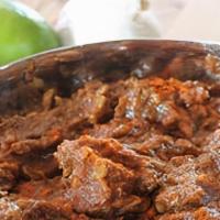 Lamb Vindaloo · Boneless lamb cooked with potato in a spicy & tangy sauce.