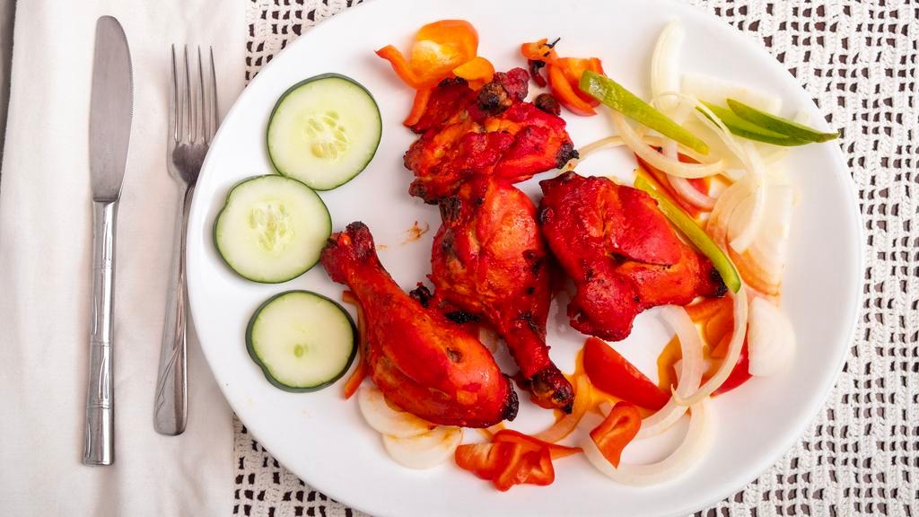 Tandoor Chicken  · Chicken leg quarters marimated in yogurt,fresh spices & lemon juice then BBQ in clay oven.