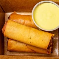 Cheesesteak Spring Rolls · Our take on a Philly classic, hand rolled with caramelized onions and American cheese. Serve...
