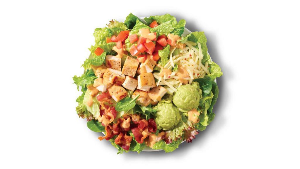 Southwest Avocado Salad · Made fresh daily with Wendy’s signature lettuce blend, pepper jack cheese, diced tomatoes, cool, creamy avocado, Applewood smoked bacon, and grilled chicken breast hot off the grill, all topped with Marzetti® Simply Dressed® Southwest Ranch Dressing. It’s zesty and Southwesty!