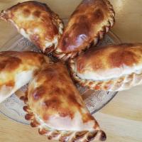 Empanadas · Empanadas Stuffed with Chicken Chipotle, Garnished with Sour Cream and Roasted Molcajete Sau...