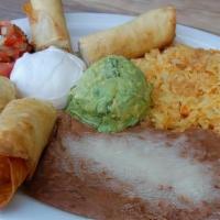 Flautas · Corn Tortillas Stuffed with Shredded Chicken, Topped with Green and Red Salsa. Garnished wit...