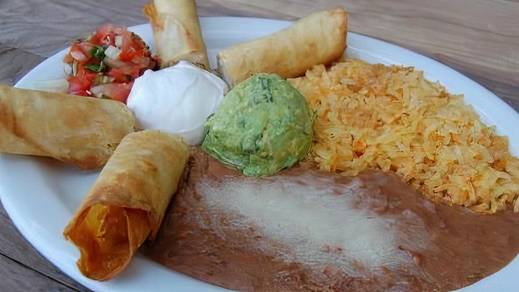Flautas · Corn Tortillas Stuffed with Shredded Chicken, Topped with Green and Red Salsa. Garnished with Cotija Cheese and Sour Cream.