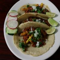 Tacos · Served with onions, cilantro, & fresh limes.