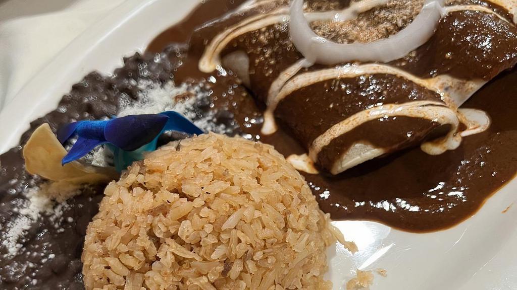 Enchiladas · Three soft corn tortillas topped with queso fresco, onions, sour cream, & your choice of tomatillo, red, or mole sauce. Served with rice & beans.