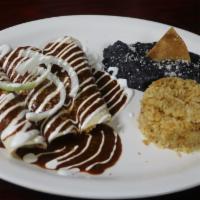Shrimp Enchiladas · Three soft corn tortillas topped with queso fresco, onions, sour cream, & your choice of tom...