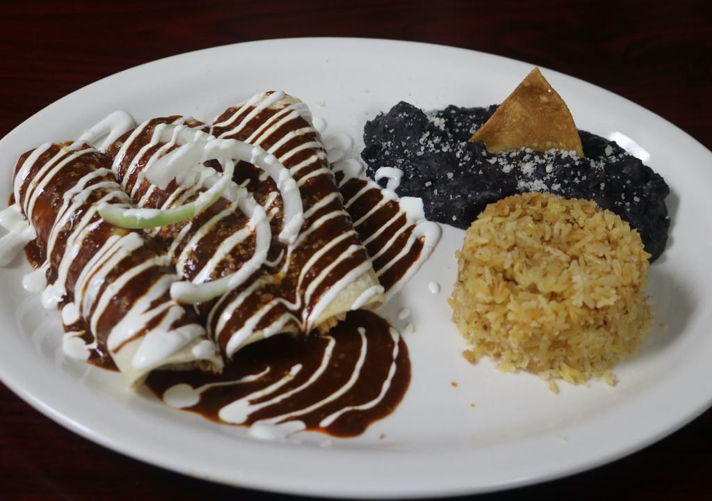 Shrimp Enchiladas · Three soft corn tortillas topped with queso fresco, onions, sour cream, & your choice of tomatillo, red, or mole sauce. Served with rice & beans.