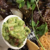 Carne Tampiquena  · 8oz grilled skirt steak topped with poblano peppers, served with guacamole, cheese enchilada...
