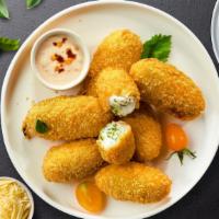Jalapeno Bombs · (Vegetarian) Fresh jalapenos coated in cream cheese and fried until golden brown.