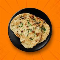 Butter Naan · A refined flour leavened flatbread, baked in a clay oven and brushed with butter.