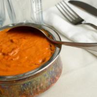 Butter Chicken · Chicken cooked in rich tomato sauce with herbs spices cream and butter then garnished with c...