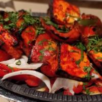 Chicken Tikka Masala · Cubes of chicken roasted in tandoor then cooked with mildly spiced tomato gravy and cream.