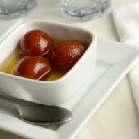 Gulab Jamun · Traditional deep-fried milk pastry served in rosewater and honey syrup with a sprinkle of co...