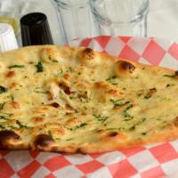 Garlic Naan · Traditional clay oven-baked white bread topped with fresh garlic and cilantro.