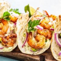 Surfer Tacos (3)Shrimp · Grilled shrimp, coleslaw, pico de gallo, Monterey jack cheese, cilantro, lime wedge drizzled...