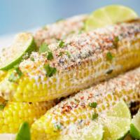 Mexican Street Corn · Fresh corn on the cob smothered in mayo sprinkled with queso fresco dusted with chili powder.