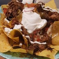 Chicken Nachos  · fresh chips covered in queso pico de gallo pinto beans jalapenos sour cream  chicken and mel...