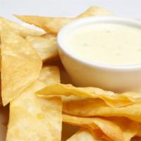 Queso & Chips · Melted hot cheese served with fresh tortilla chips.