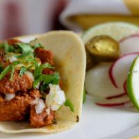 Al Pastor Taco · Crispy marinated pork with pineapple, corn tortilla, cilantro and onion.  Served with lime a...
