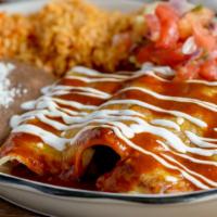 Al Pastor Enchilada · Crispy marinated pork with pineapple wrapped in  a corn tortilla topped with ancho sauce and...