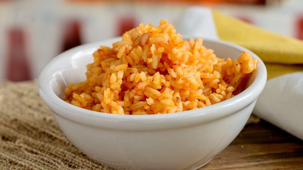 Red Rice · House rice seasoned with an achiote/tomato blend.  (Vegetarian/Vegan)