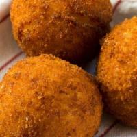 Buffalo Balls · Our nonna meatballs breaded and fried then tossed in our buffalo hot sauce and topped with a...