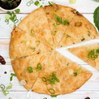 Scallion Pancake · Wheat flour stuffed with scallions and herbs served with ginger sauce.