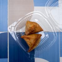 Desi Samosa · Fried pastry with a savoury filling of spiced potatoes, onions and peas.