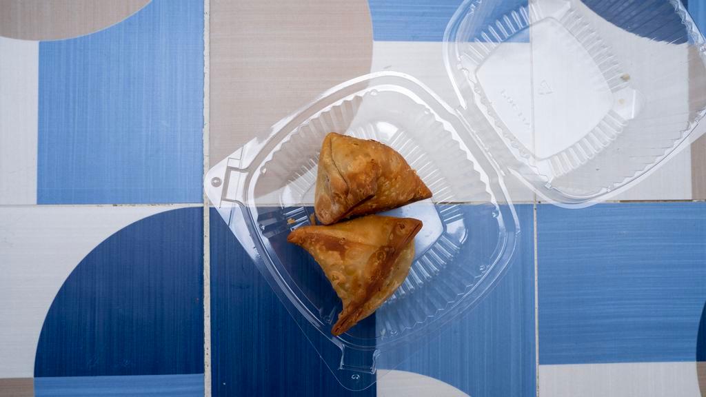 Desi Samosa · Fried pastry with a savoury filling of spiced potatoes, onions and peas.