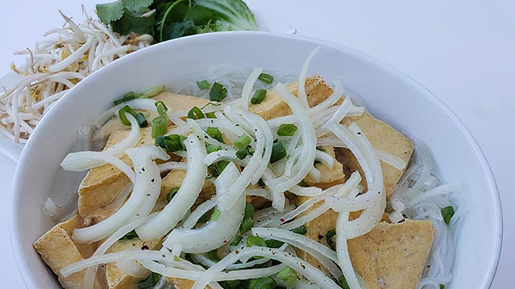 Tofu Pho · Fried Soft Tofu noodle soup now serving in a to-go bowl. Vietnamese rice noodle soup with cilantro, onion, scallions, basil, jalapeno, lime, and bean sprouts. Soup on the side!