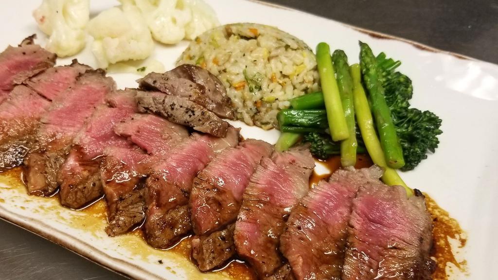 Steak Teriyaki · Pan-seared shallot and thyme marinated sliced 10oz steak topped with our house made teriyaki sauce served with seasonal vegetables and vegetable fried rice.