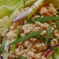 Northeast-Style Salad (Larb) · Spicy. Minced chicken mixed with rice powder, Thai chili, lime juice, and green herbs.