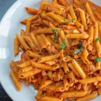 Penne & Sausage · Penne with hot sausage in a creamy tomato basil sauce.