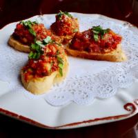 Bruschetta (V) · Toasted baguettes, tomato, sun-dried tomato, basil, garlic, parmesan cheese, Italian herbs.