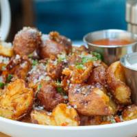 Parmesan Punched Potatoes · Deep-fried red bliss potatoes, tossed with Parmesan cheese and served with hot sauce and blu...