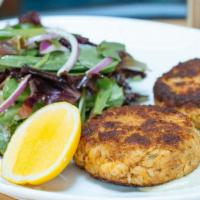 Crab Cakes · Two crab cakes pan-roasted and served with cilantro-jalapeno remoulade and crisp green salad.